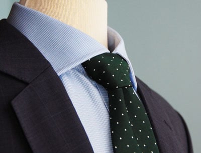 Blue blazer green polka dot tie.