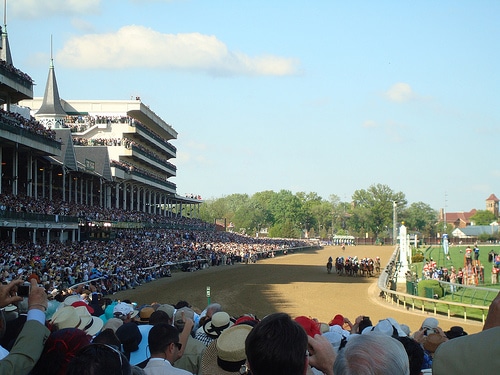 The crowd seeing the horse racing in derby.
