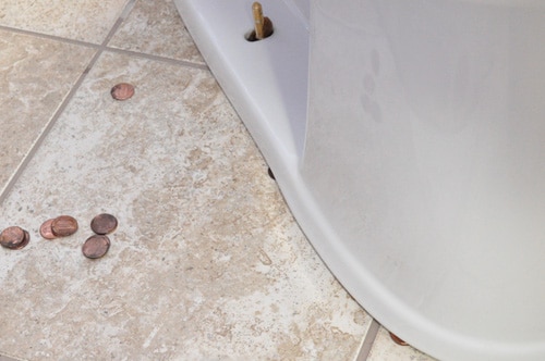 A new toilet seat leveling using pennies to level.