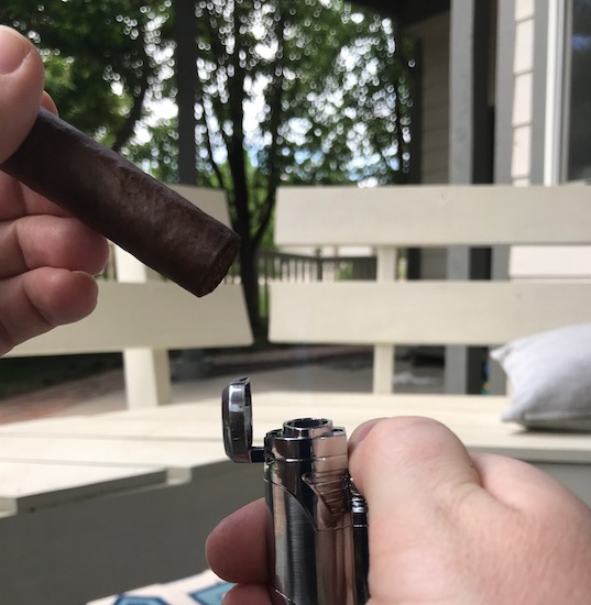 Toasting the foot of cigar.