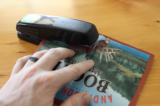 A man stapling packet cover.