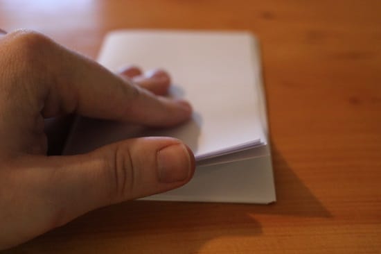 A man folding pages with hand.
