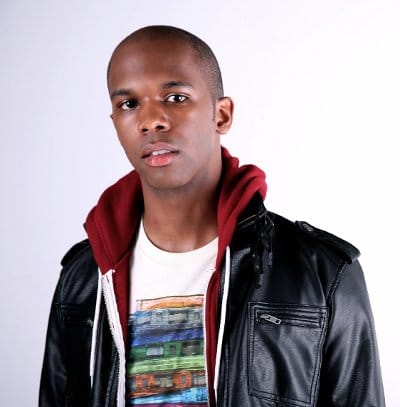 A young songwriter in a leather jacket and t-shirt.
