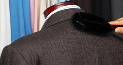 Brushing,caring and cleaning of men suit jacket for wardrobe.