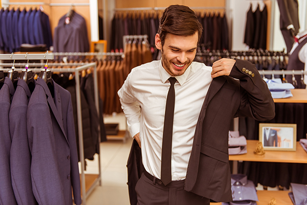 A man in a suit browsing a store to perfect his Men's Style.