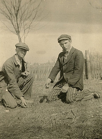 mumbleypeg1 Vintage men playing mumblety-peg pocket knife game.