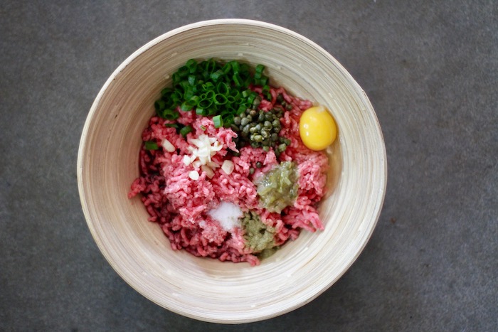 Ingredients in a bowl to make a burger.