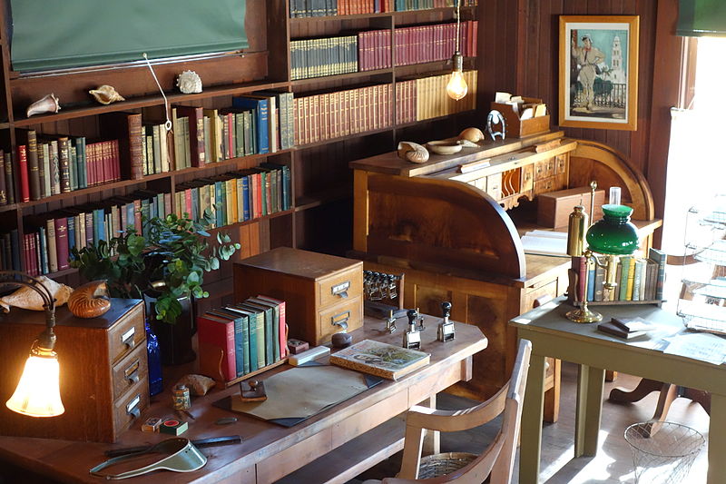 A room lined with books and a desk, reminiscent of libraries.