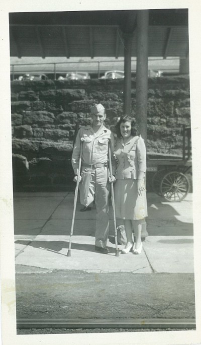 toye2 Vintage army man missing his leg standing with young lady.