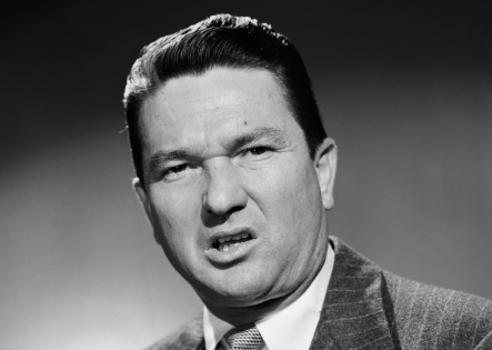 A black and white photo of a man in a suit.