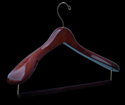 Wooden suit hanger for a wardrobe.